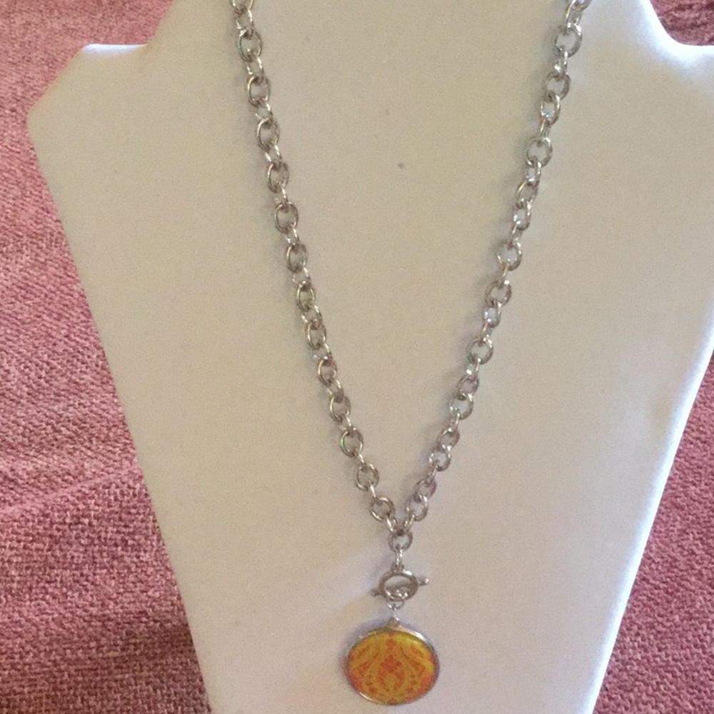 Silver tone necklace with removable medallions.